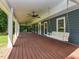 Spacious porch with a swing and ceiling fans, providing a comfortable outdoor space for relaxing and entertaining at 1215 Brookgreen Dr, Cary, NC 27511