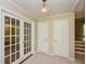 Entryway featuring tile flooring, French doors, white doors, and a stylish chandelier at 1215 Brookgreen Dr, Cary, NC 27511