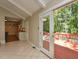 View of the dining area leading to the modern kitchen, outdoor deck, and the swimming pool at 1215 Brookgreen Dr, Cary, NC 27511