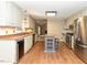 Bright kitchen with stainless steel appliances, center island with breakfast bar, and wood flooring at 1215 Brookgreen Dr, Cary, NC 27511
