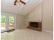 Vaulted living room shows a brick fireplace and french doors to deck at 1215 Brookgreen Dr, Cary, NC 27511