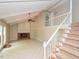 Bright living room offers stairs, fireplace, and french doors to deck at 1215 Brookgreen Dr, Cary, NC 27511
