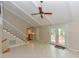 Bright living room featuring a vaulted ceiling, staircase, and french doors to a deck at 1215 Brookgreen Dr, Cary, NC 27511
