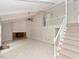 Open living room boasts high ceilings, a brick fireplace, and staircase to the second floor at 1215 Brookgreen Dr, Cary, NC 27511