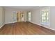Inviting living room with wood flooring and double doors leading to the entrance at 1215 Brookgreen Dr, Cary, NC 27511