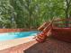 Backyard pool area boasts brick patio, wooden deck, and privacy fence at 1215 Brookgreen Dr, Cary, NC 27511