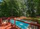 Inviting pool area surrounded by a red deck and a wooden fence at 1215 Brookgreen Dr, Cary, NC 27511