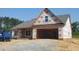 Charming exterior elevation of a new home with a two-car garage and a gable roof design at 123 Maple Dr, Erwin, NC 28339