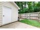Fenced backyard with turf and a storage building at 129 Assembly Ct, Cary, NC 27511