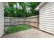 Fenced backyard with patio and artificial turf, great for outdoor enjoyment at 129 Assembly Ct, Cary, NC 27511