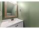Charming half bathroom with a modern sink, white vanity, and sage colored walls at 129 Assembly Ct, Cary, NC 27511