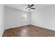 Bright bedroom features hardwood flooring, a ceiling fan, and a window at 129 Assembly Ct, Cary, NC 27511