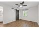 Bright bedroom with a modern ceiling fan, barn door closet, and a window for natural light at 129 Assembly Ct, Cary, NC 27511
