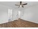Spacious bedroom features hardwood flooring, a ceiling fan, and multiple doors at 129 Assembly Ct, Cary, NC 27511