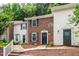 Charming townhome with brick facade, black shutters, and meticulously landscaped front yard at 129 Assembly Ct, Cary, NC 27511