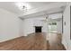 Open-concept living room with hardwood floors, fireplace, and sliding doors to backyard at 129 Assembly Ct, Cary, NC 27511