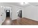 Bright living room view to entry and kitchen featuring hardwood floors and fresh paint at 129 Assembly Ct, Cary, NC 27511