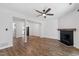 Bright, open living space featuring a fireplace and hardwood floors, seamlessly connecting to kitchen at 129 Assembly Ct, Cary, NC 27511