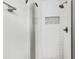 Modern shower with white subway tile, glass doors, and recessed niche at 129 Assembly Ct, Cary, NC 27511