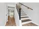 Bright stairway featuring modern railing and hardwood flooring leading to upper level at 129 Assembly Ct, Cary, NC 27511