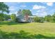 View of the large backyard with a deck and mature trees, creating a private outdoor space at 1413 Roy Averette Dr, Raleigh, NC 27603