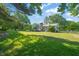 Spacious backyard featuring a large lawn, mature trees, and a deck perfect for outdoor gatherings at 1413 Roy Averette Dr, Raleigh, NC 27603