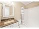 Bathroom with granite vanity, mirror, toilet and shower with striped curtain at 1413 Roy Averette Dr, Raleigh, NC 27603
