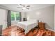This bright bedroom boasts a ceiling fan and hardwood floors at 1413 Roy Averette Dr, Raleigh, NC 27603