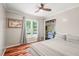 Cozy bedroom with hardwood floors, a double window, a comfortable bed and a closet with built-in desk at 1413 Roy Averette Dr, Raleigh, NC 27603