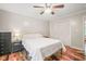 This bedroom features wood floors, ceiling fan and closet space at 1413 Roy Averette Dr, Raleigh, NC 27603