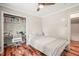 Comfortable bedroom featuring a built-in desk in the closet and hardwood floors at 1413 Roy Averette Dr, Raleigh, NC 27603