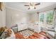 Bright Bedroom featuring a white crib, changing table, hardwood floors, and natural light from the window at 1413 Roy Averette Dr, Raleigh, NC 27603