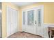 Bright entryway featuring decorative glass front door, closet for storage, and neutral tile flooring at 1413 Roy Averette Dr, Raleigh, NC 27603