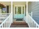 Charming entryway with a light blue door and decorative glass, framed by white columns and railings at 1413 Roy Averette Dr, Raleigh, NC 27603