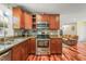 Updated kitchen features granite countertops, stainless steel appliances, and wood floors at 1413 Roy Averette Dr, Raleigh, NC 27603