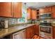 This kitchen features granite counters, stainless appliances, tile backsplash and wood floors at 1413 Roy Averette Dr, Raleigh, NC 27603