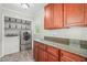 This laundry room features storage cabinets and granite counters at 1413 Roy Averette Dr, Raleigh, NC 27603