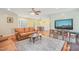 Open-concept living and dining area with hardwood floors, large windows, and light-filled rooms at 1413 Roy Averette Dr, Raleigh, NC 27603