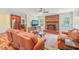 Inviting living room with brick fireplace, hardwood floors, and view into the kitchen at 1413 Roy Averette Dr, Raleigh, NC 27603