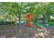 Wooden playground with swings and a slide, set in a charming backyard with mature trees at 1413 Roy Averette Dr, Raleigh, NC 27603