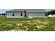 Exterior view of the backyard showing the lawn and side of the house at 148 Coharie Dr, Lillington, NC 27546