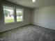 Comfortable carpeted bedroom with bright windows overlooking the green lawn at 148 Coharie Dr, Lillington, NC 27546