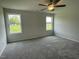 Bedroom featuring plush carpeting, ceiling fan, and windows with views of the property at 148 Coharie Dr, Lillington, NC 27546