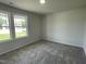 Comfortable carpeted bedroom with bright windows offering natural light at 148 Coharie Dr, Lillington, NC 27546