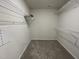 Walk in closet featuring ample storage space and carpet flooring at 148 Coharie Dr, Lillington, NC 27546