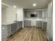 Modern kitchen featuring granite countertops, stainless appliances, and grey cabinetry at 148 Coharie Dr, Lillington, NC 27546