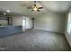 Spacious living room featuring plush carpeting, a ceiling fan, and an open concept design at 148 Coharie Dr, Lillington, NC 27546