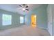 Primary bedroom with ceiling fan, carpet, two windows, and a view to the bathroom at 151 Braeside Ct, Cary, NC 27519
