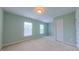 Bedroom with two windows for natural light, closet, and neutral carpet at 151 Braeside Ct, Cary, NC 27519