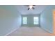 Bedroom with a ceiling fan, two windows, and a view to the next room at 151 Braeside Ct, Cary, NC 27519
